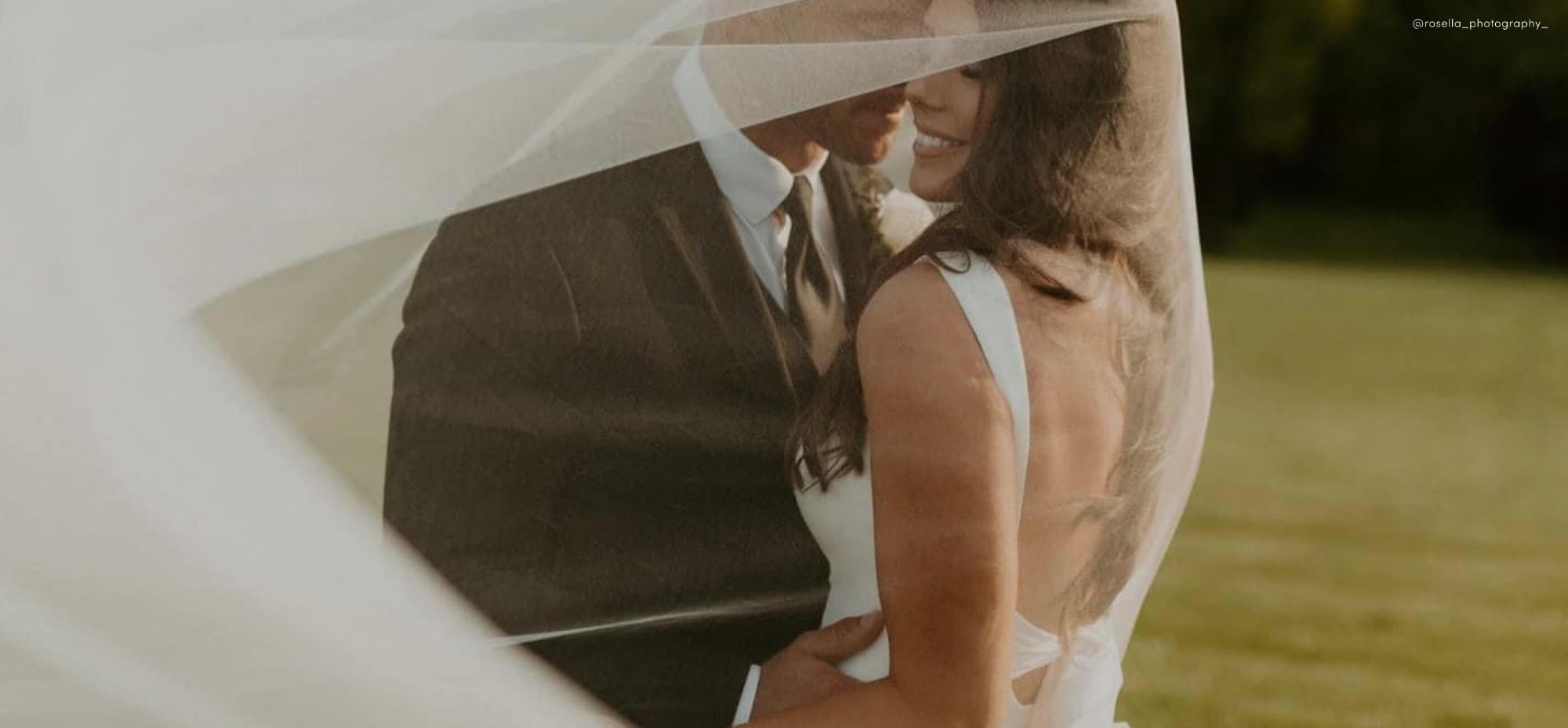 Сouple wearing a white gown and a black suit